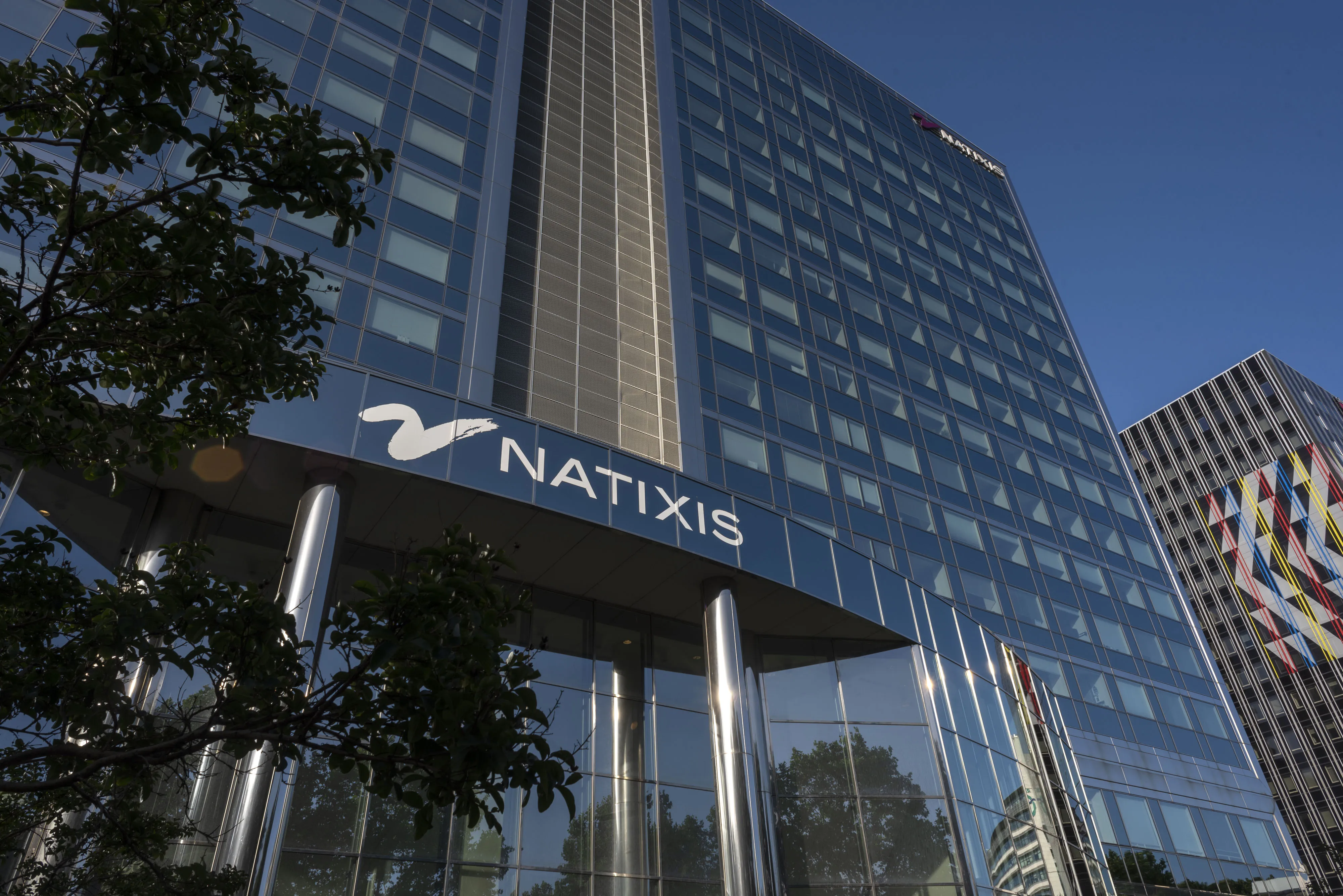 The Natixis SA logo sits on the company's offices in Paris, France.