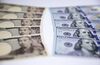 Japanese 10,000 yen, left, and U.S. 100 dollar banknotes are arranged for a photograph in Tokyo, Japan, on Tuesday, Sept. 5, 2017. Japanese stocks fell as the yen strengthened while investors prepared themselves for the economic damage that Hurricane Irma may inflict on Florida and mulled U.S. President Donald Trump’s most recent comments on North Korea.