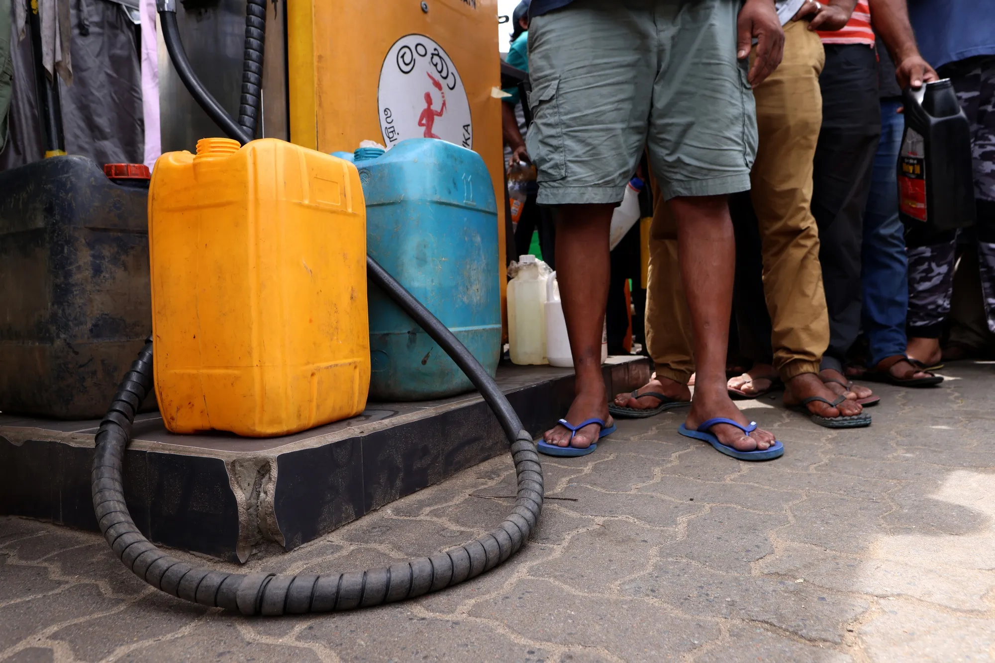 Customers queue to buy fuel at a gas station in Kandy, Sri Lanka, on&nbsp;June 17.