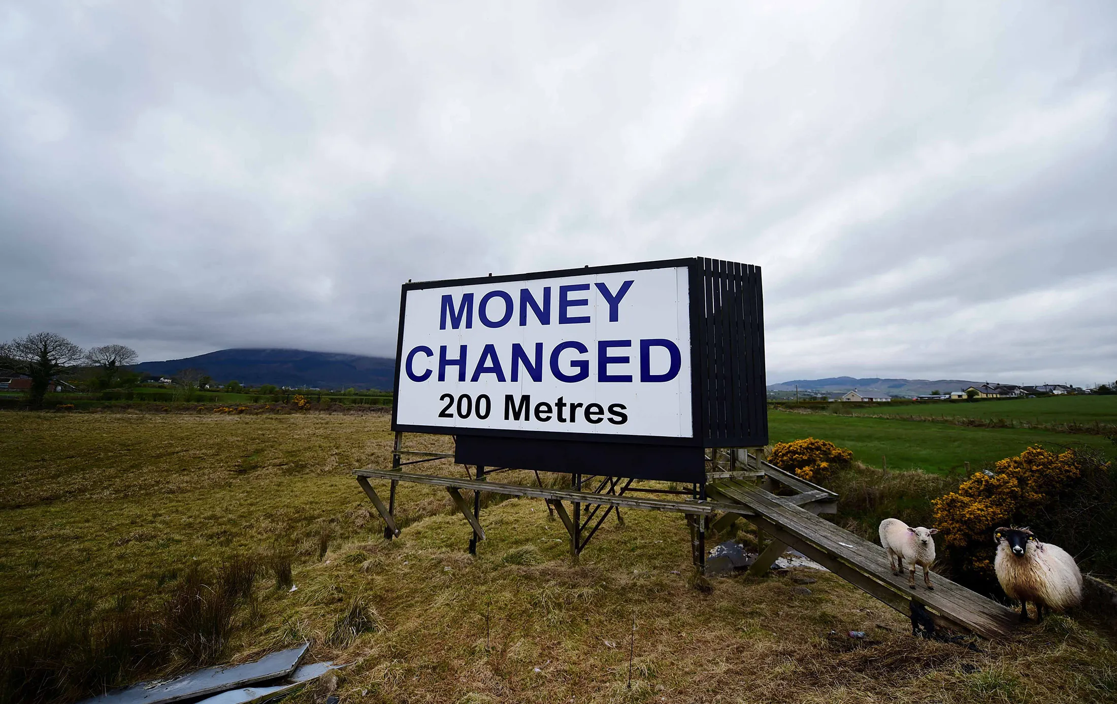 A billboard advertising money changing services sits in Newry, Northern Ireland.
