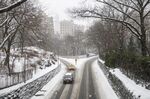 Vehicles drive through Central Park during a winter storm in New York, on Feb. 18.