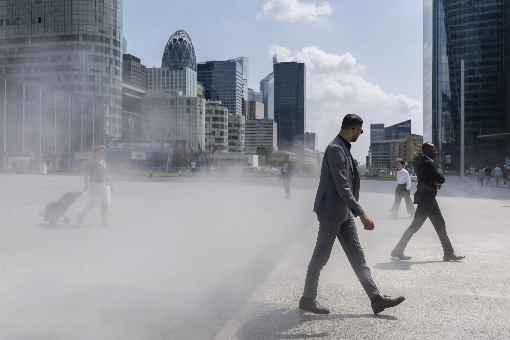 A water mister cools pedestrians&nbsp;in the La Defense business district of&nbsp;Paris.