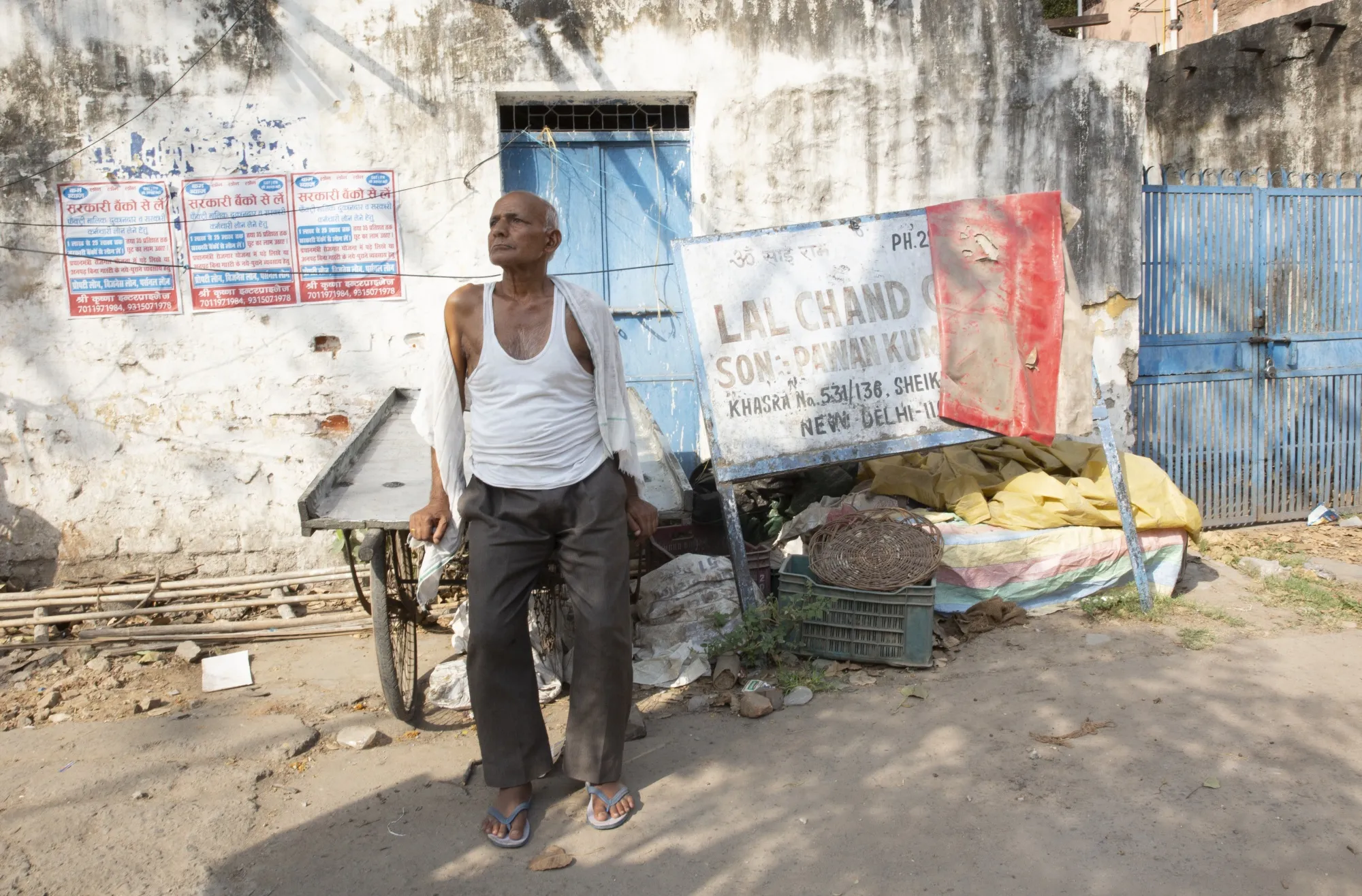 Mahavir Singh, a fruit vendor, sleeps in his cart to keep cool at night.