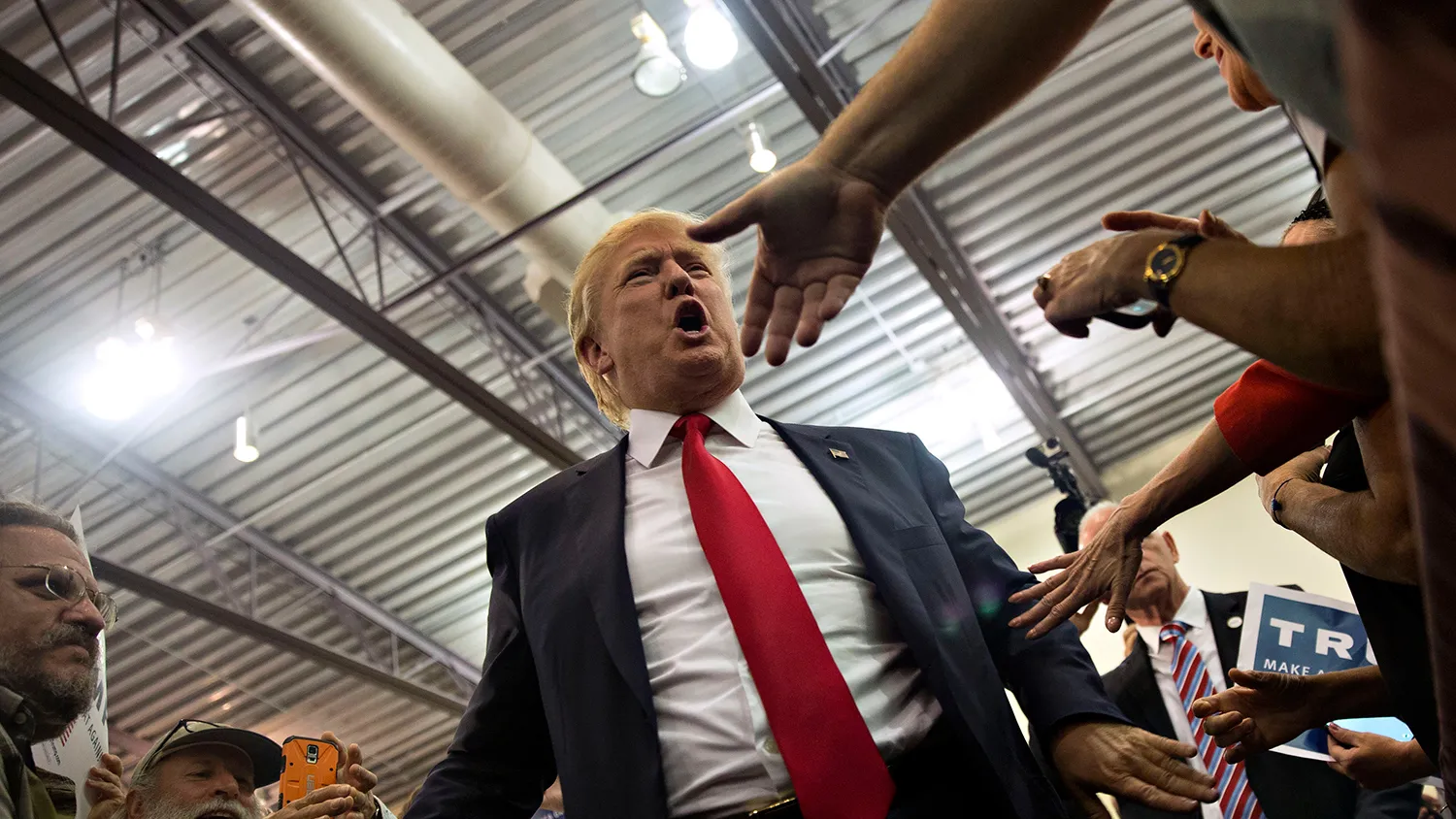 Donald Trump, president and chief executive of Trump Organization Inc. and 2016 Republican presidential candidate, greets attendees during a rally at Grand River Center in Dubuque, Iowa, U.S., on Tuesday, Aug. 25, 2015.
