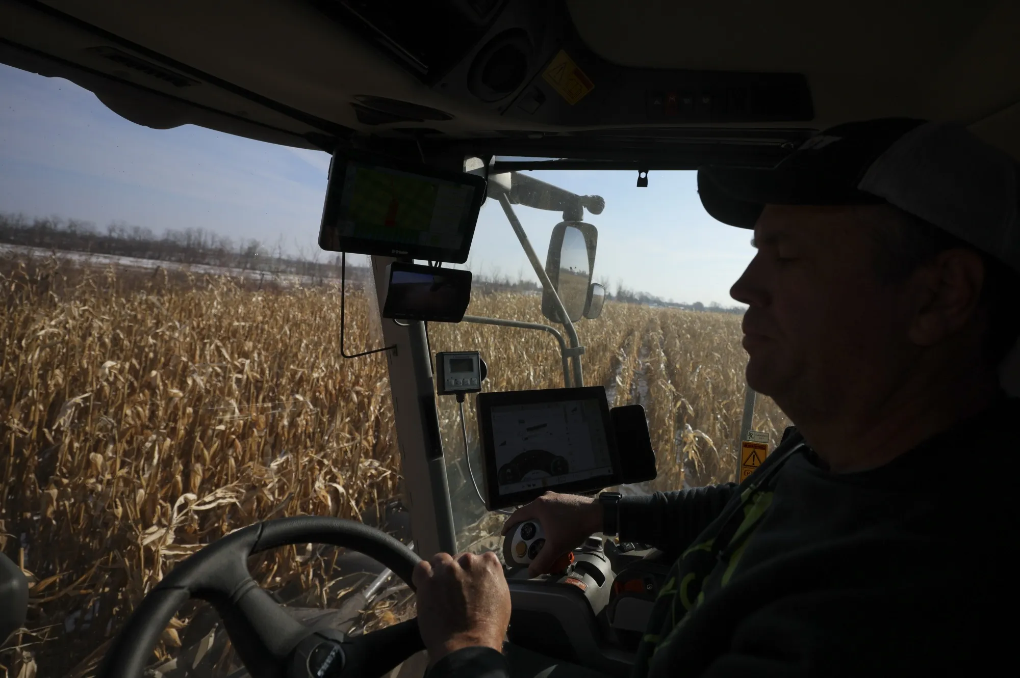 A farmer harvests corn on a farm in Chesterville, Ontario last November.