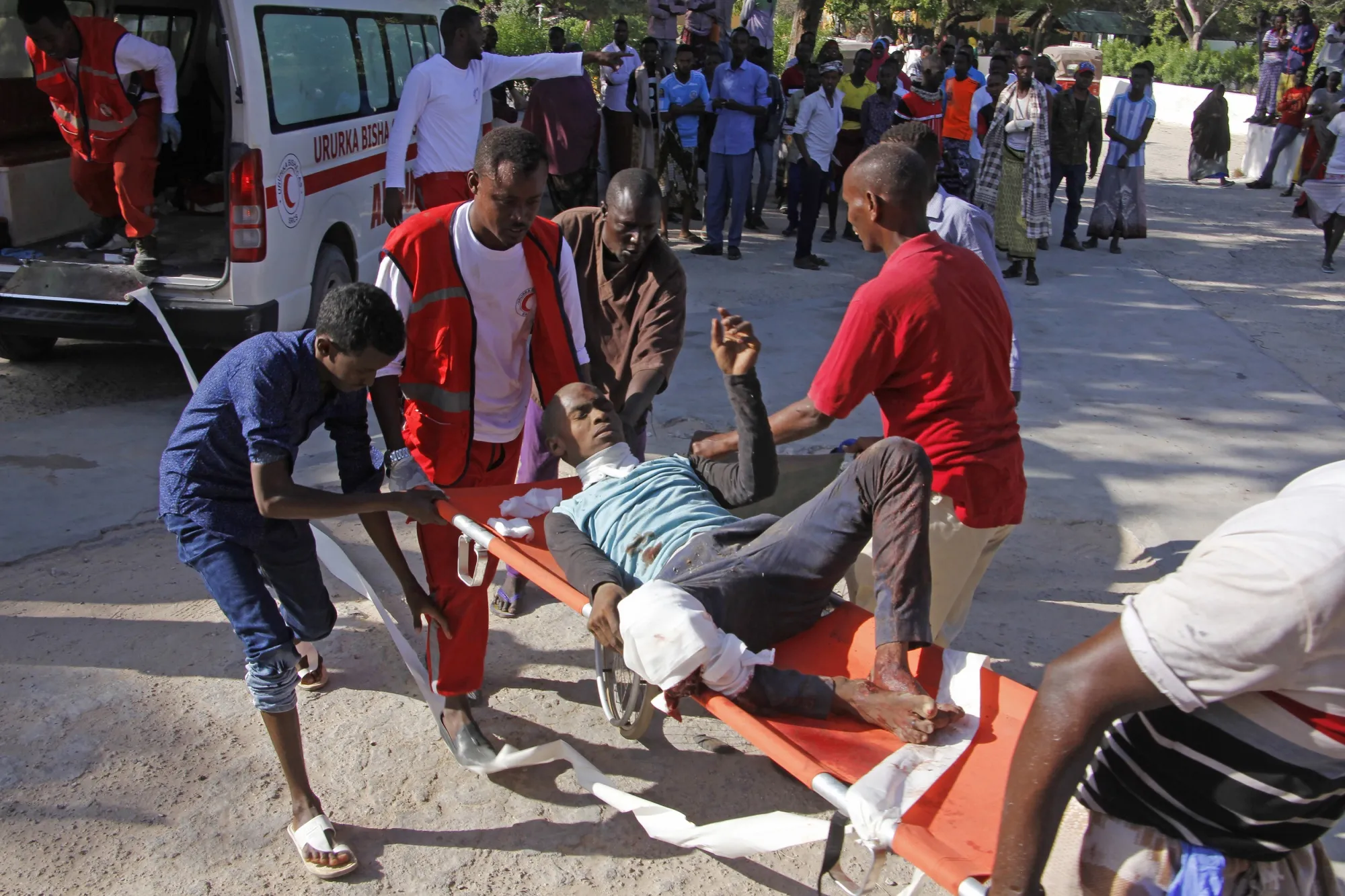 Medical personnel carry a civilian who was wounded in suicide car bomb attack at check point in Mogadishu on Dec. 28.