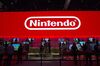 Attendees play the Nintendo Co. Super Smash Bros. Ultimate at the company's booth during the E3 Electronic Entertainment Expo in Los Angeles, California, U.S., on Tuesday, June 12, 2018. Nintendo announced a slate of new titles for its new hybrid console Switch, moving to capitalize on early excitement for its newest system.