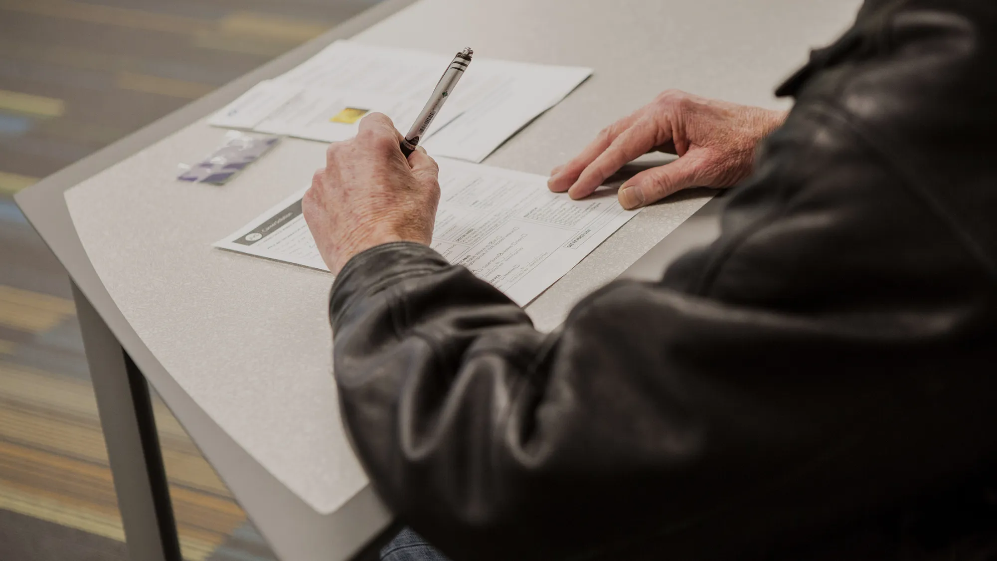 A job seeker fills out an application form during a United States Postal Service (USPS) recruitment event in Boston, Massachusetts, U.S., on Wednesday, Dec. 9, 2015. The U.S. Department of Labor is scheduled to release initial jobless claims figures on December 10.

