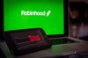 The GameStop Corp. logo on a smartphone and the Robinhood website on a laptop computer arranged in Hastings-On-Hudson, New York, U.S., on Friday, Jan. 29, 2021. GameStop Corp. advanced on Friday and was on track to recoup much of Thursdays $11 billion blow after Robinhood Markets Inc. and other brokerages eased trading restrictions on the video-game retailer.