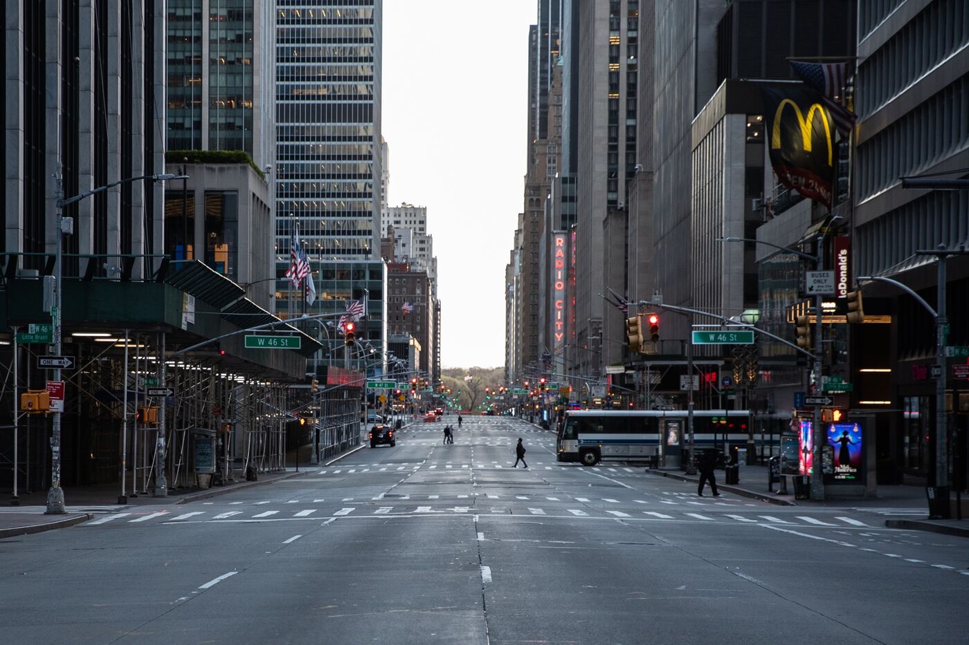 Pedestrians walk along a nearly empty street in New York on April 1.