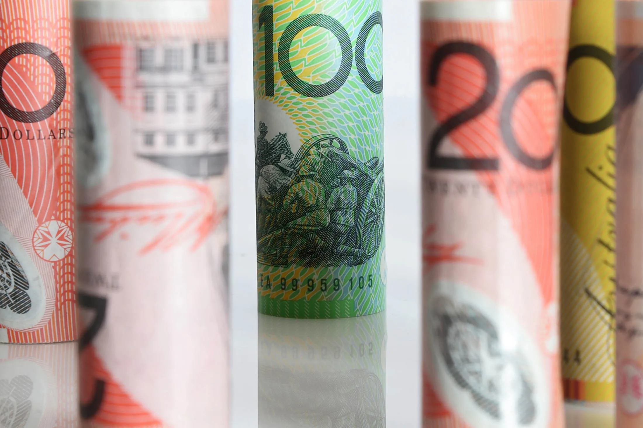 Rolls of Australian dollar bill notes of different denominations are arranged for a photograph in Melbourne, Australia, on Thursday, Aug. 15, 2013.
