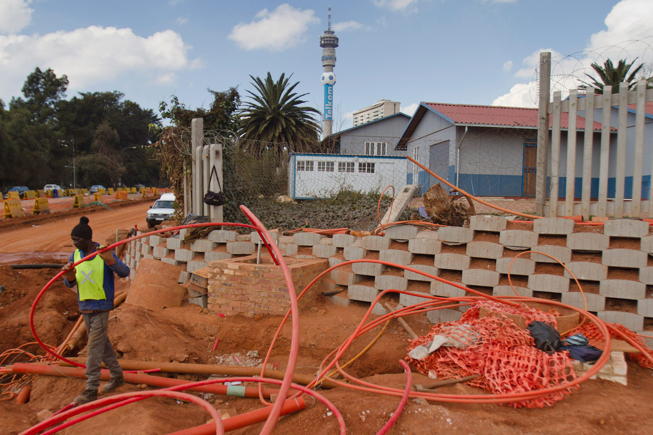 A worker lays cabling for a high speed telecommunications line for Neotel Ltd., a fixed-line operator part-owned by Tata Communications Ltd., in the center of Johannesburg.
