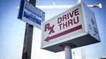 A sign directs customers to the pharmacy drive-thru of a CVS Health Corp. store in Chicago on Nov. 6, 2016.
