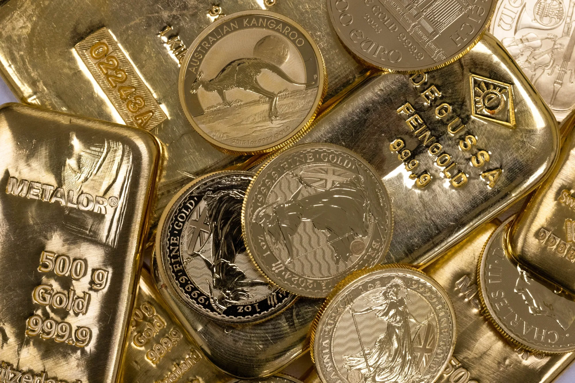 A selection of gold bars and one-ounce gold coins arranged at Gold Investments Ltd. bullion dealers in London, UK.