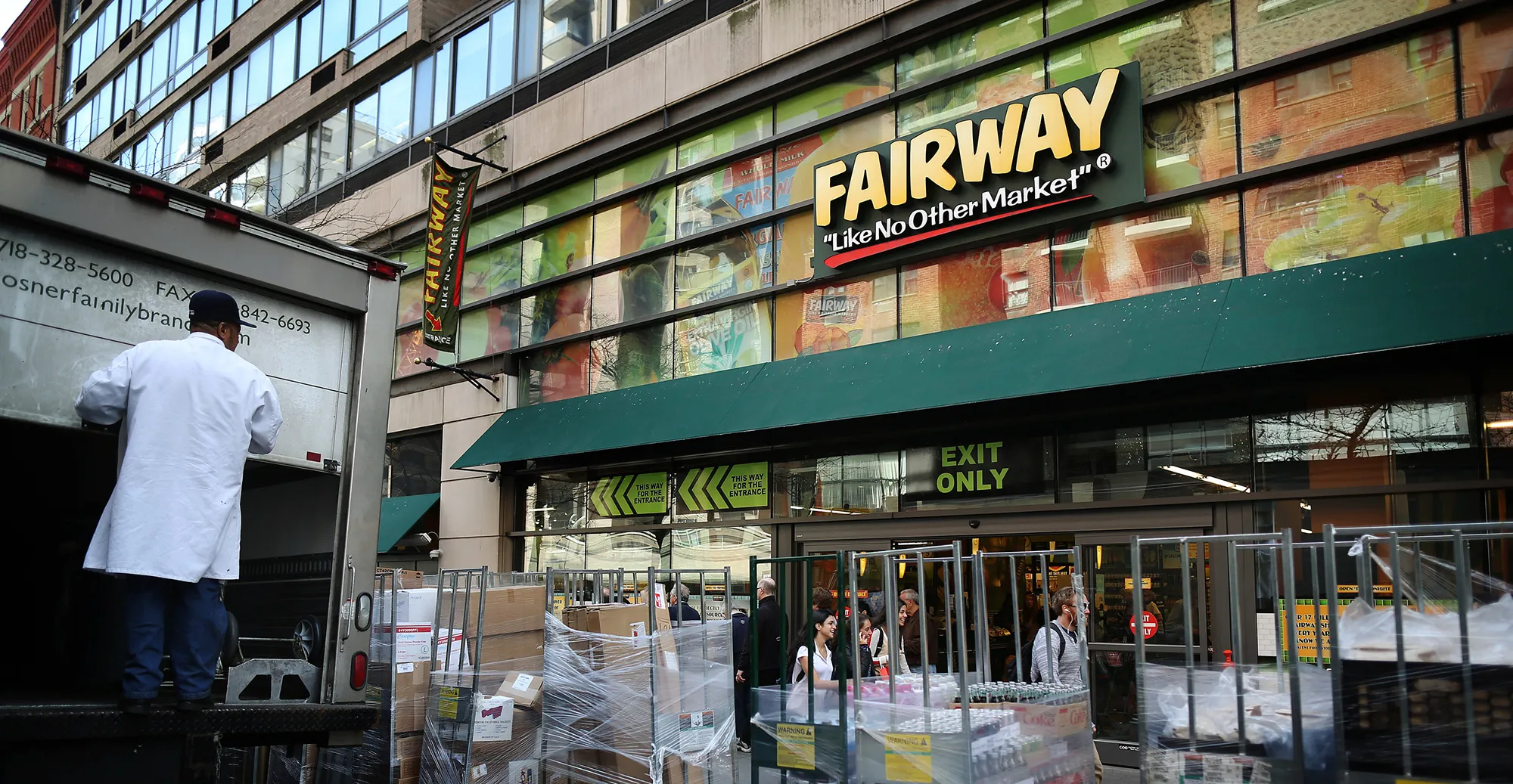 A worker unloads new items to be stocked in front of a Fairway market in New York.