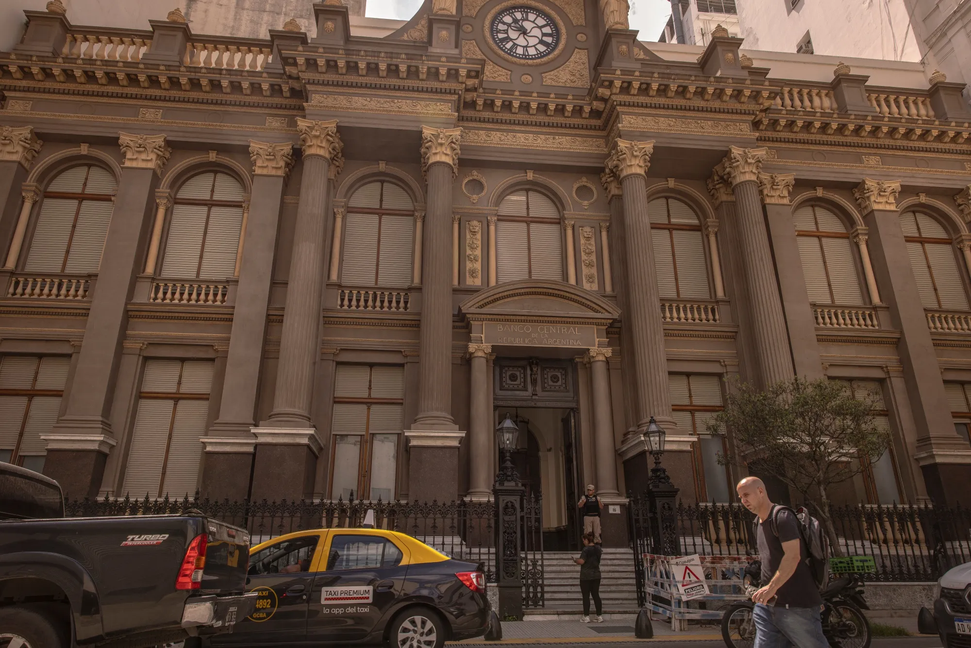 Pedestrians walk past the Central Bank of Argentina in Buenos Aires.