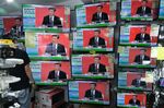 A news report on Chinese President Xi Jinping's speech in the city of Shenzhen is shown on television screens inside a store in Hong Kong on Oct. 14.