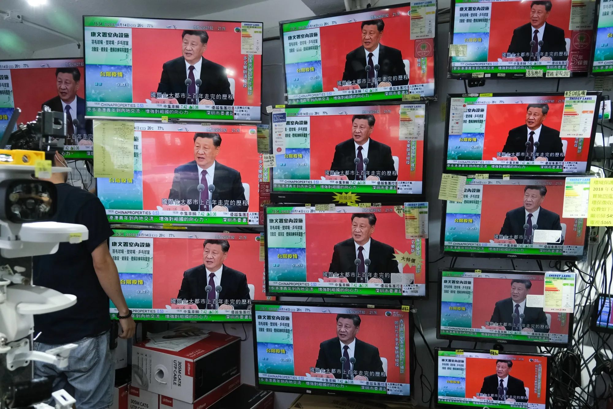 A news report on Chinese President Xi Jinping's speech in the city of Shenzhen is shown on television screens inside a store in Hong Kong on Oct. 14.