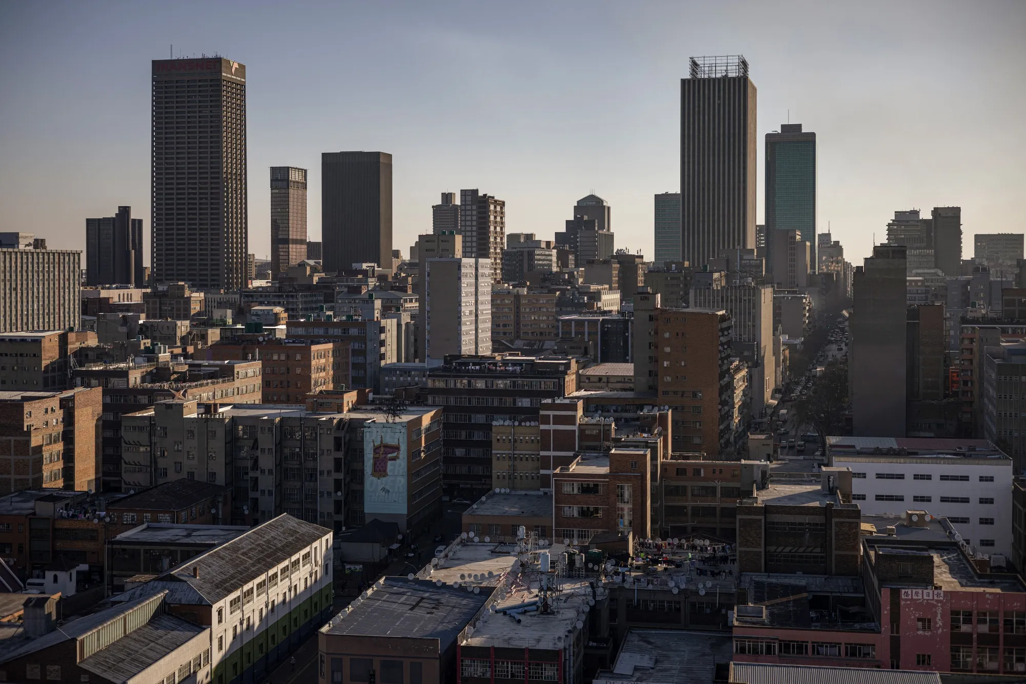 Commercial office buildings and high-rise towers beyond blocks of flats in the central business district in Johannesburg.