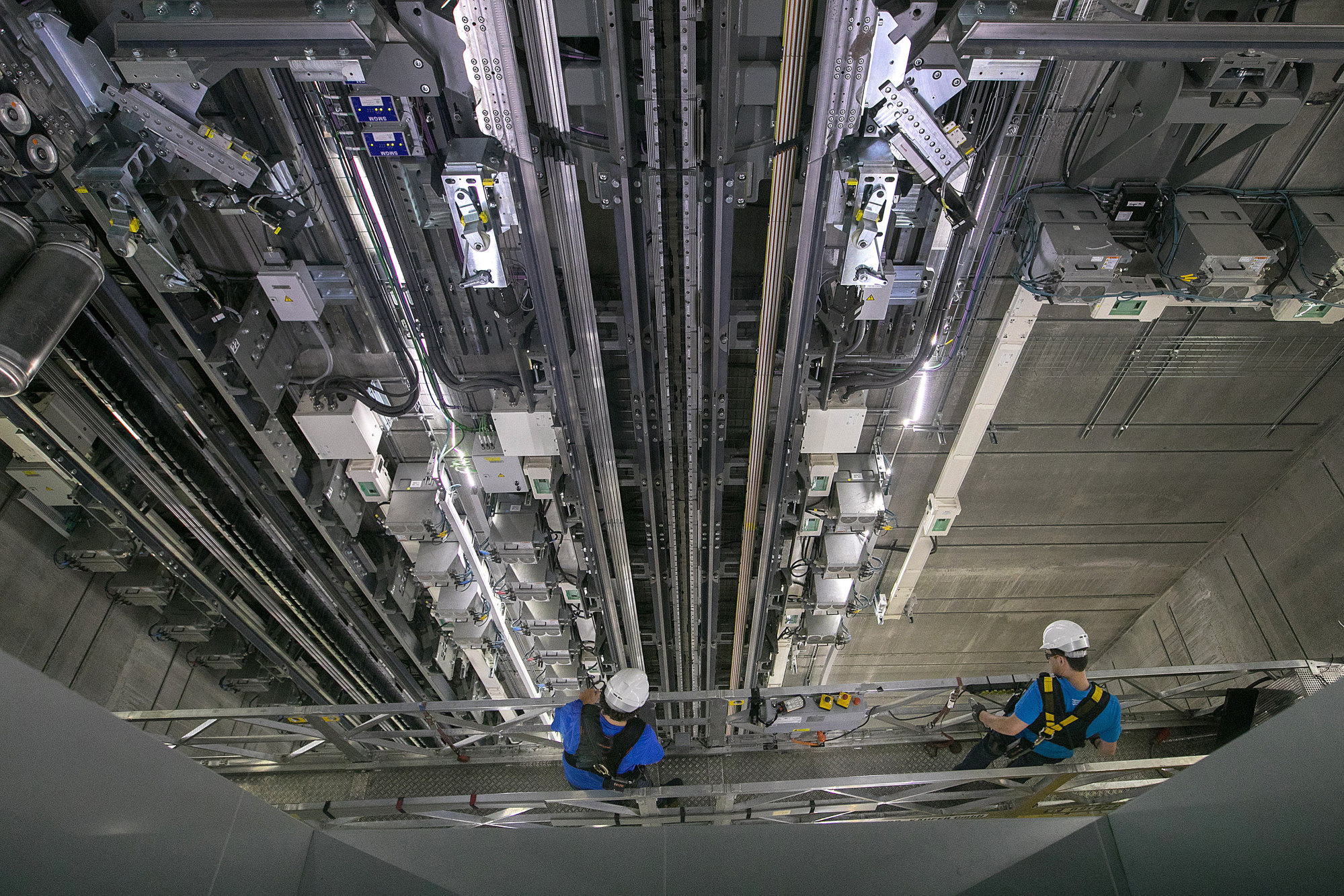 Engineers carry out maintenance work inside the Multi system elevator shaft, which enables vertical and horizontal movement, inside the Thyssenkrupp Elevator AG test tower in Rottweill.