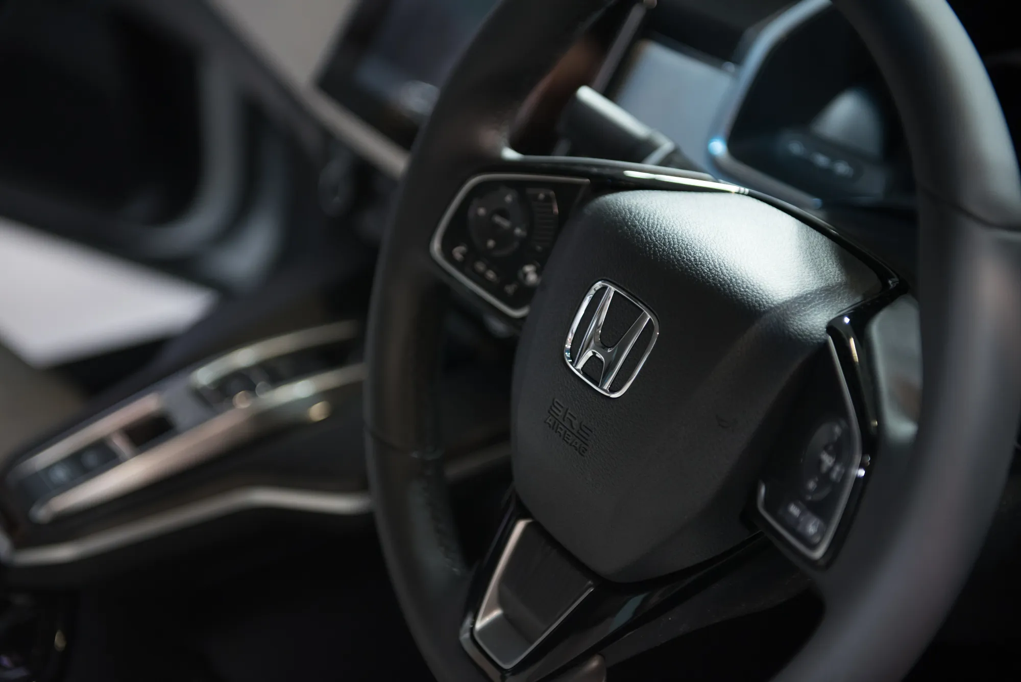 A Honda Motor Co. badge on the steering wheel of a vehicle&nbsp;in Tokyo.