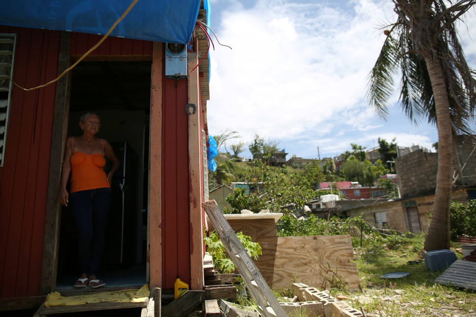 Bexaida Torres stands in the door of what is left of her home after Hurricane Maria hit the island in September, in Canovanas, Puerto Rico, on April 10.