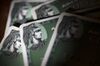 American Express Co. corporate credit cards are arranged for a photograph in Washington, D.C., U.S., on Wednesday, April 15, 2015. American Express, which is accepted at fewer stores than Visa Inc. and MasterCard Inc., is expected to release earnings figures data on April 16.