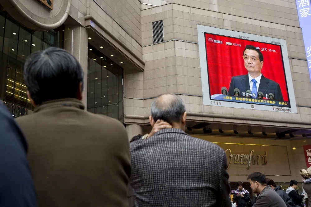 A monitor showing coverage of Li Keqiang, China's premier, at the opening session of the National People's Congress (NPC) is displayed in the Causeway Bay district of Hong Kong, China, on Wednesday, March 5, 2014. Photographer: Brent Lewin/Bloomberg