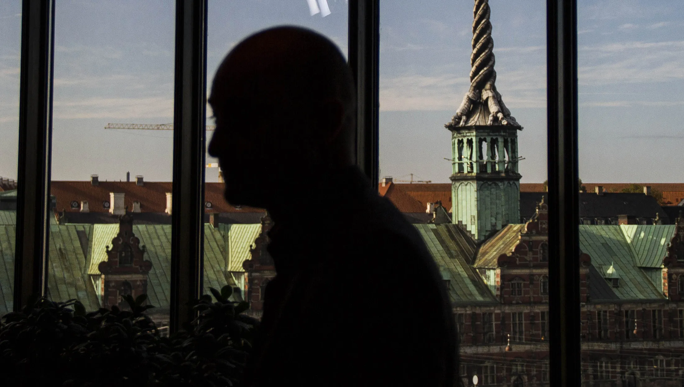 A spire stands above the old stock exchange building known as the Boersen on the city skyline seen from the central bank headquarters in Copenhagen.
