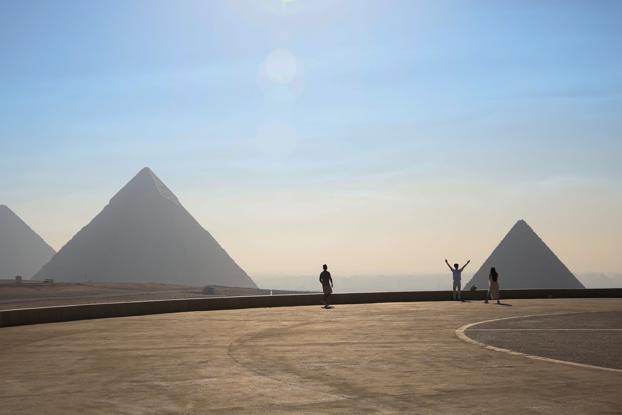 Tourists take photos in front of the Giza pyramids in Giza, Egypt, on Thursday, May 29, 2025. Orascom Pyramids Entertainment, a company owned by Egyptian billionaire Naguib Sawiris, invested 1.5 billion Egyptian pounds to develop the Giza Plateau and will operate it for 15 years through a public-private partnership agreement signed in 2018. Photographer: Islam Safwat/Bloomberg
