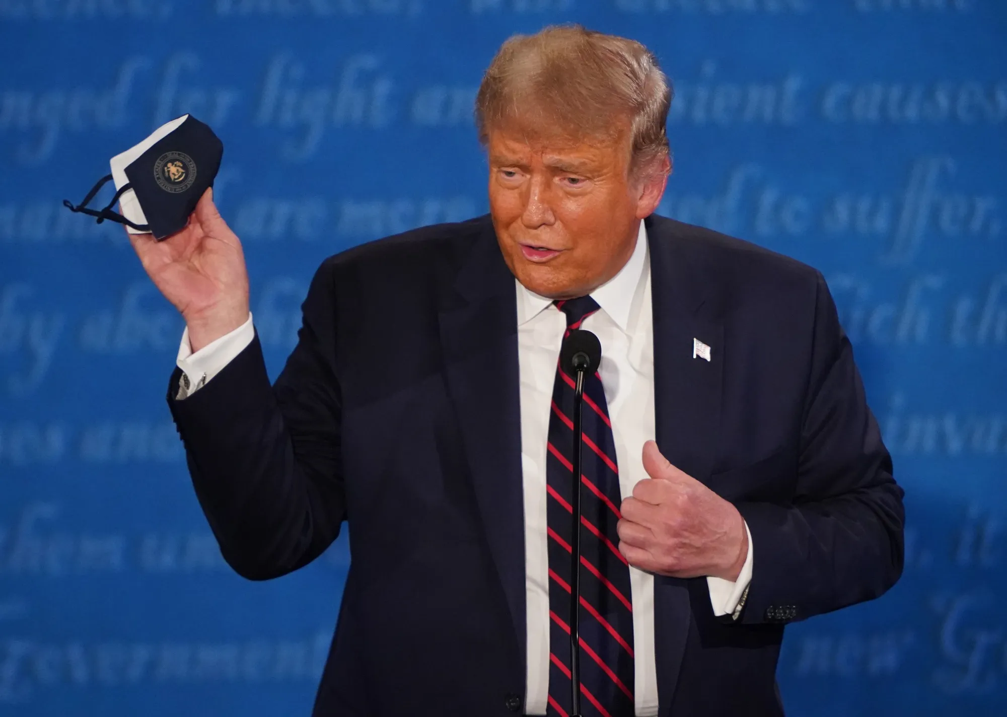 U.S. President Donald Trump holds a protective mask during the first U.S. presidential debate.
