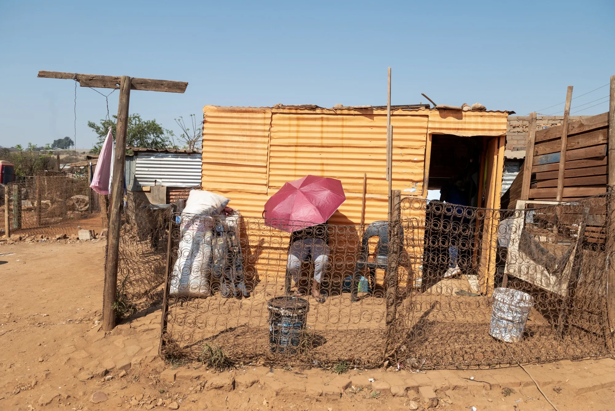 Residents enduring high temperatures spend much of their time seeking shade, in the Itireleng shanty town near Pretoria, South Africa, on Aug. 20.