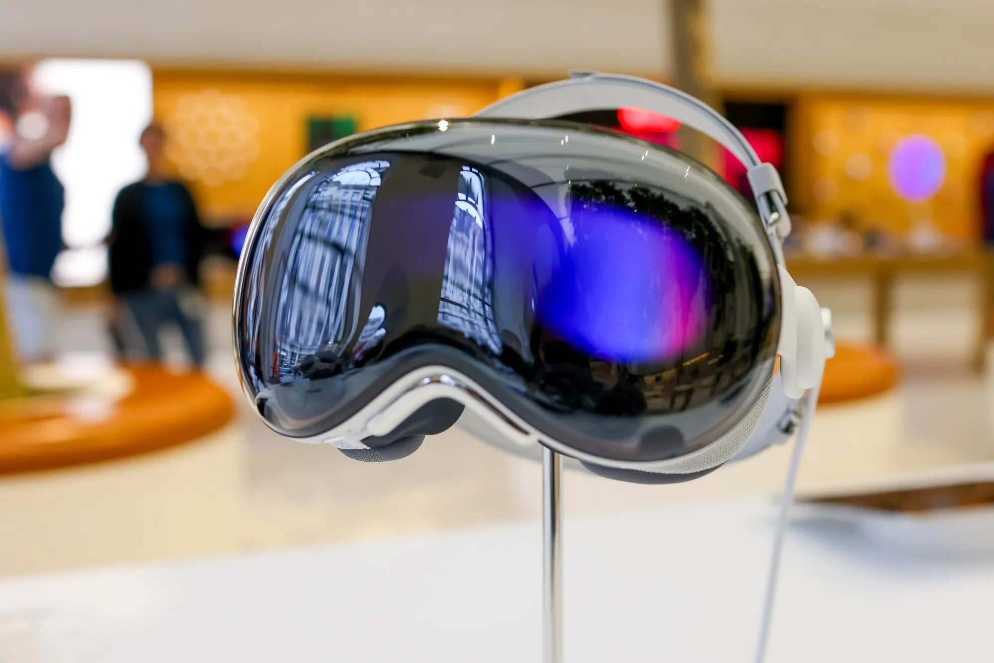 An Apple Vision Pro headset on display at a retail store.