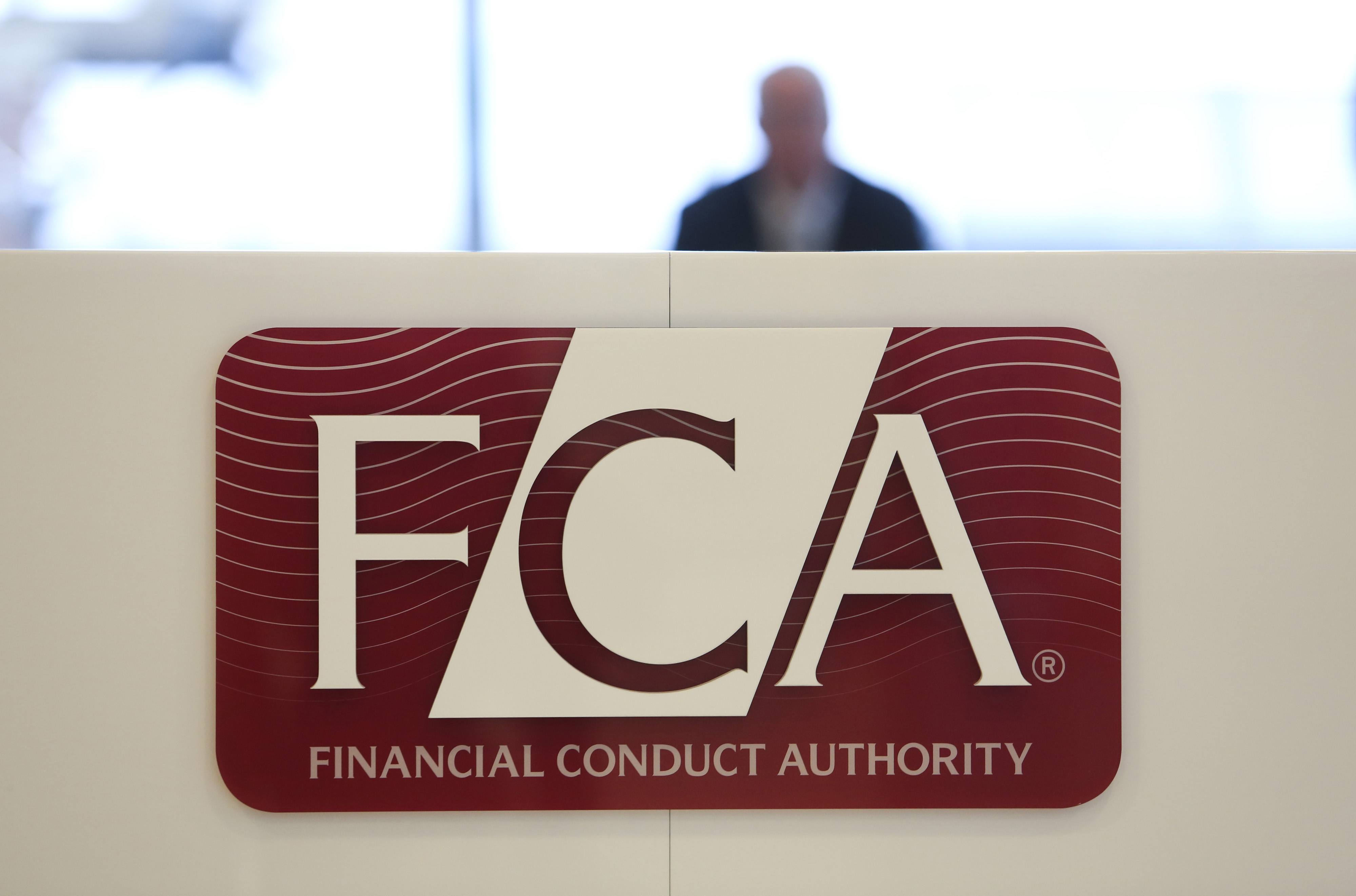A logo sits on a sign in the reception area of the headquarters of the Financial Conduct Authority in London.