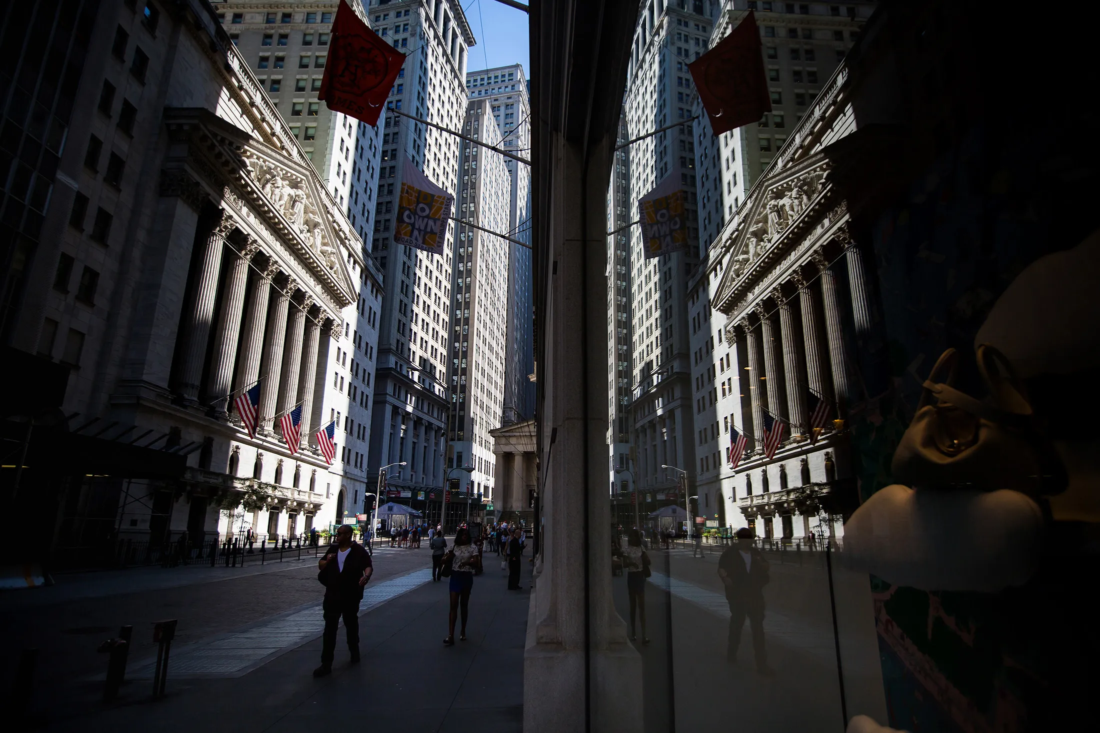 Pedestrians walk past the New York Stock Exchange (NYSE) in New York, U.S., on Monday, June 12, 2017.
