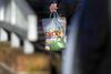 A customer carries a shopping bag outside a Tesco Plc supermarket in Chelmsford, U.K. Chris Ratcliffe/Bloomberg
