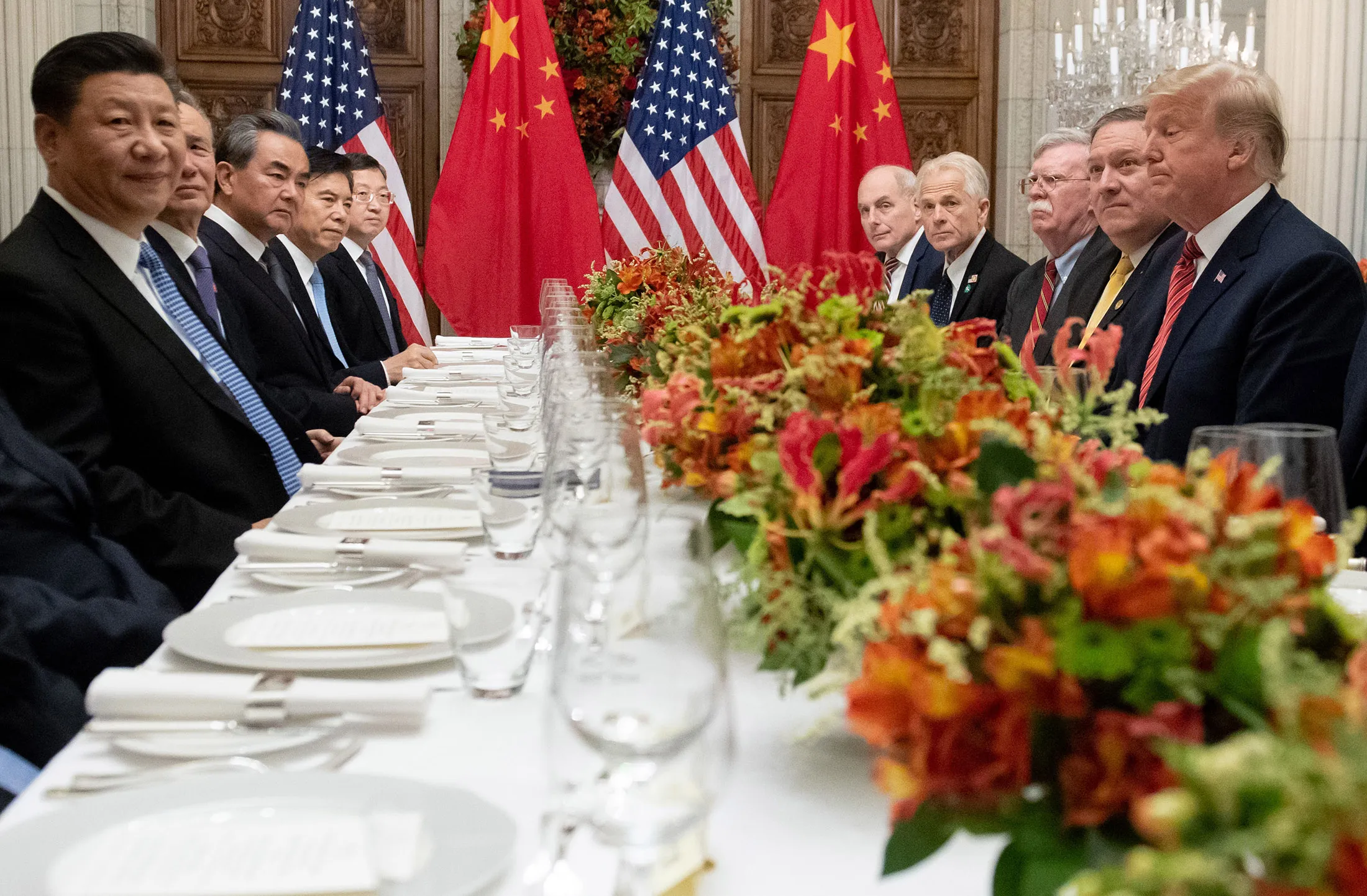 Donald Trump, right, and Xi Jinping, left, along with members of their delegations on Dec. 01.