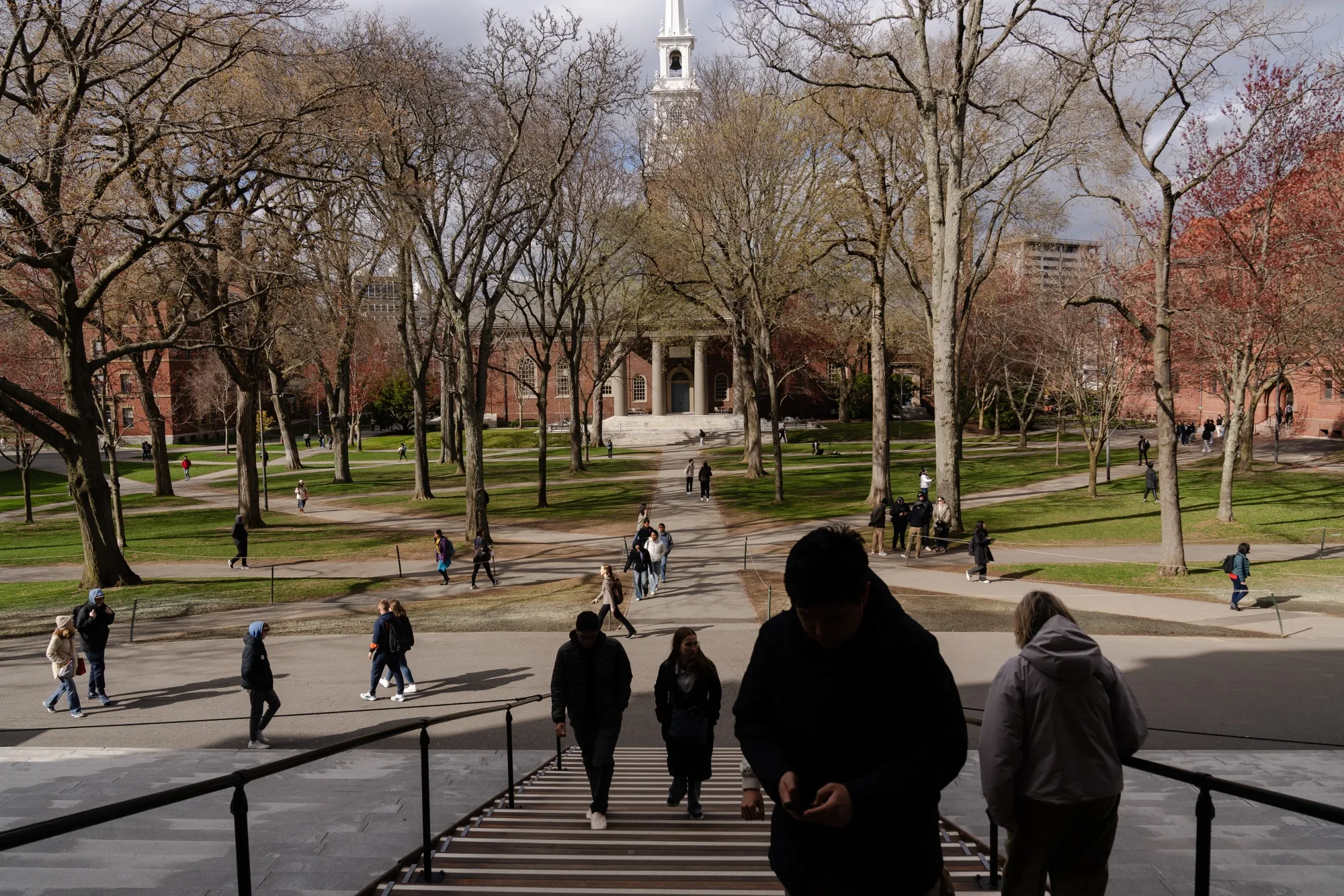 Pedestrians walk through Harvard Yard on the Harvard University campus in Cambridge, Massachusetts, on April 16.