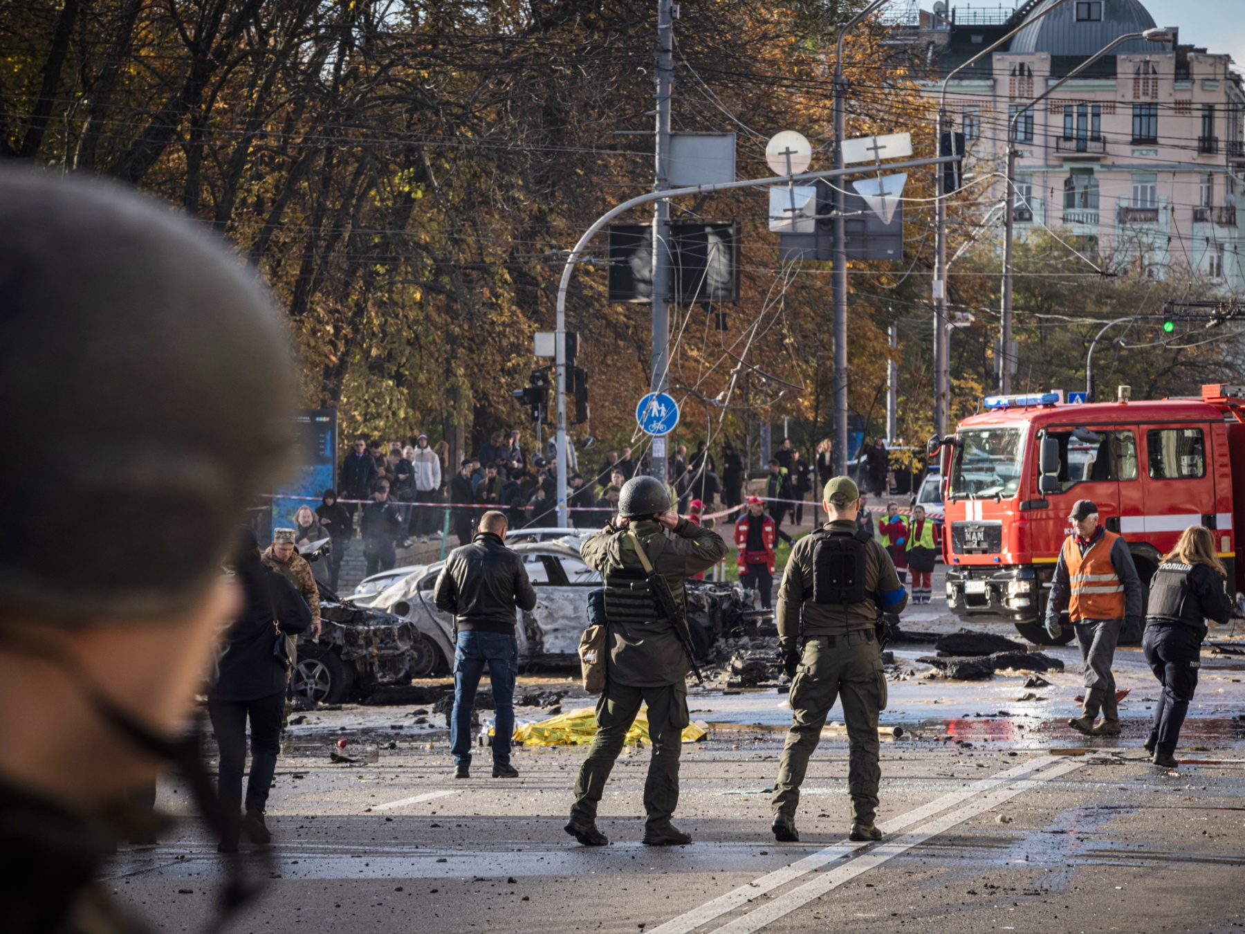 Emergency services attend the scene of a Russian missile attack&nbsp;in Kyiv on Oct. 10.