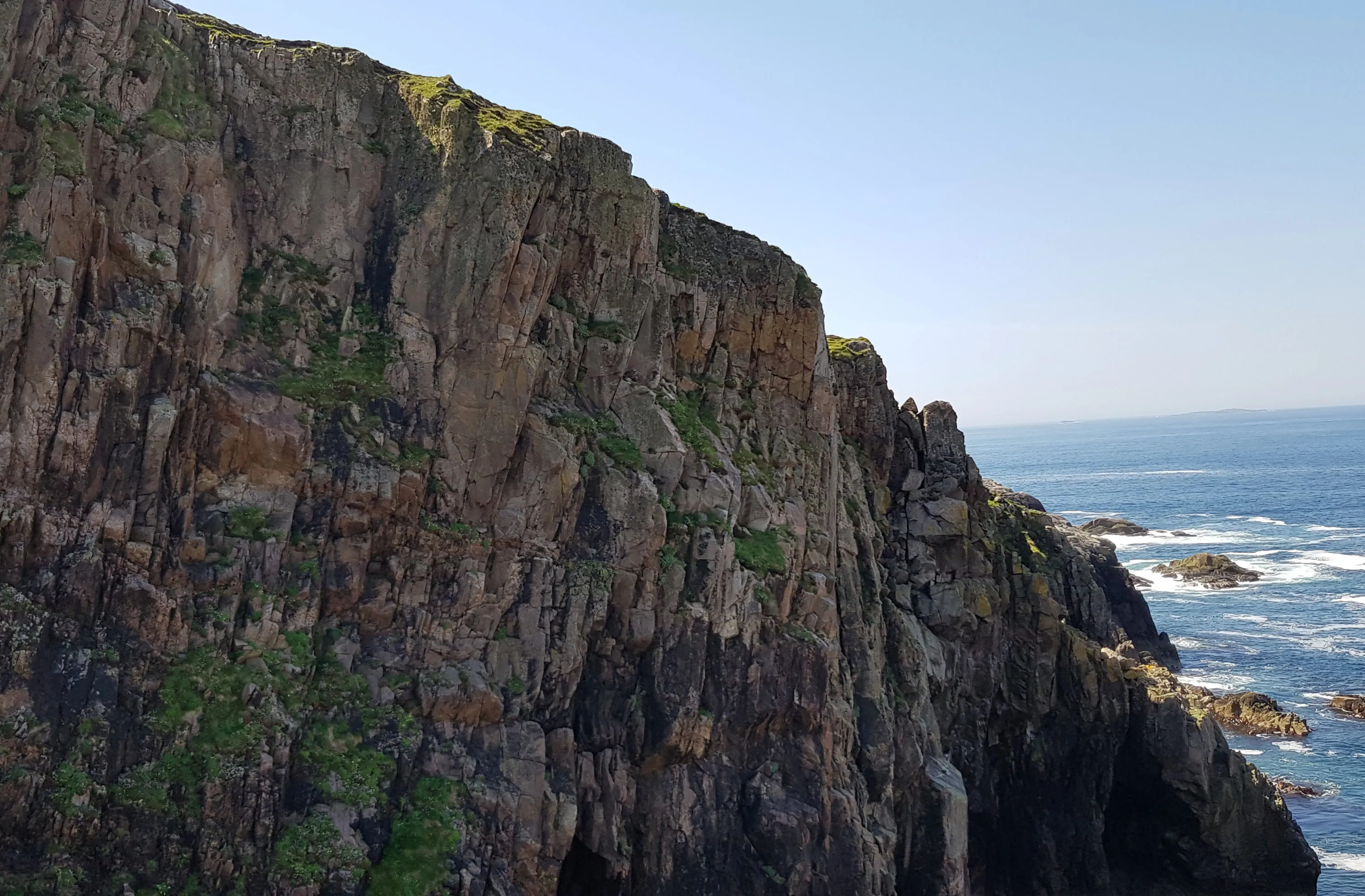 Granite outcrops with extensive vertical fracturing sit on the Isle of Harris in Scotland.