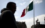 The Mexican flag flies in the Zocalo main square in Mexico City, Mexico.