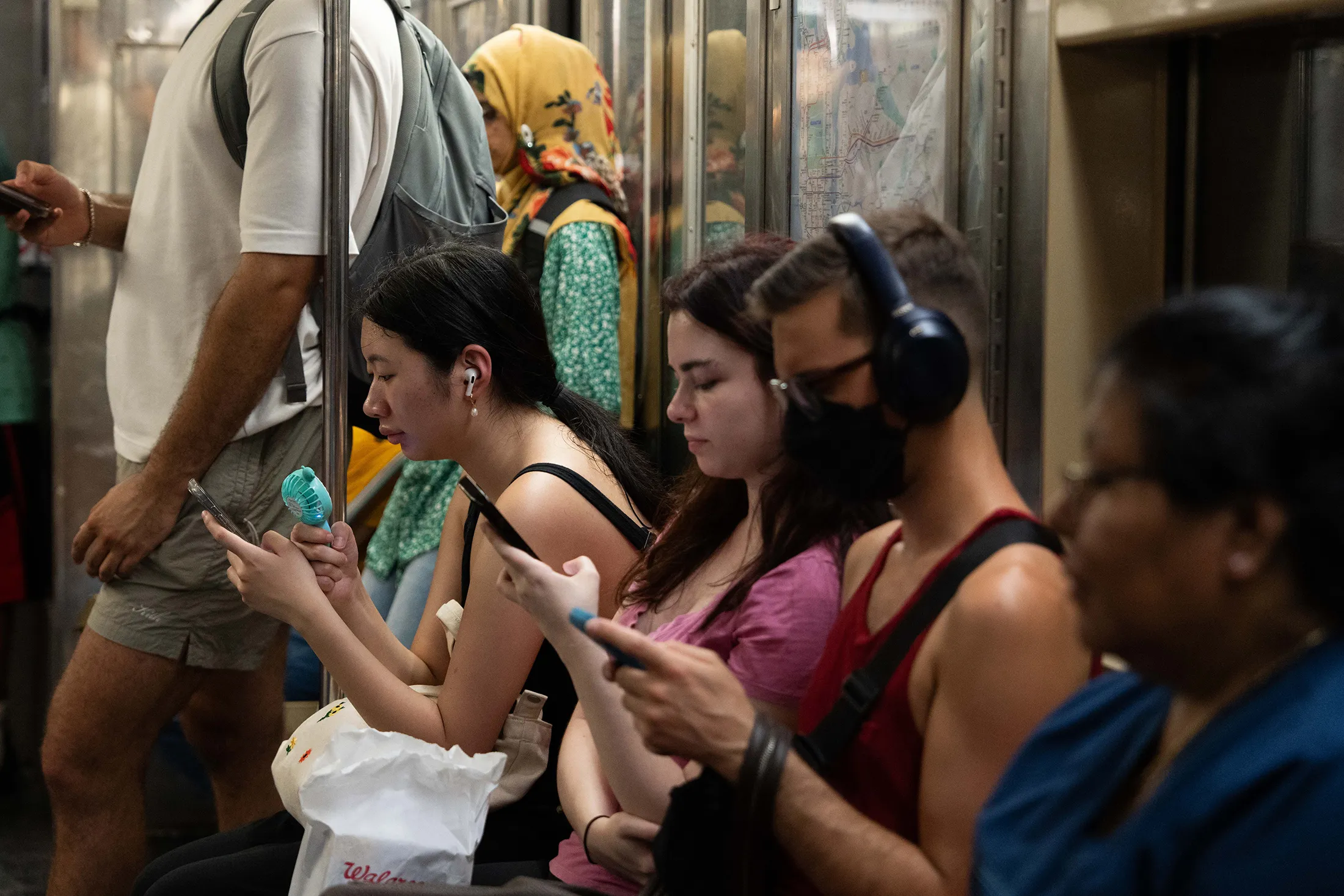 A passenger uses a fan to cool down on the 1 Train subway in New York City on July 16.&nbsp;