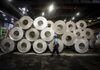 An employee walks by rolls of sheet aluminum in a storage area ahead of distribution at the Impol Seval AD Sevojno plant in Sevojno, Serbia, on Friday, Aug. 17, 2018. Following the 20 percent slump in aluminum since April, some producers can’t cover their costs as the price of alumina -- their key raw material -- moves higher.