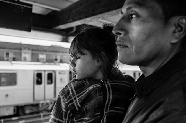 Pedro Tonito holds his daughter Fernanda on a subway platform in the Queens borough of New York.