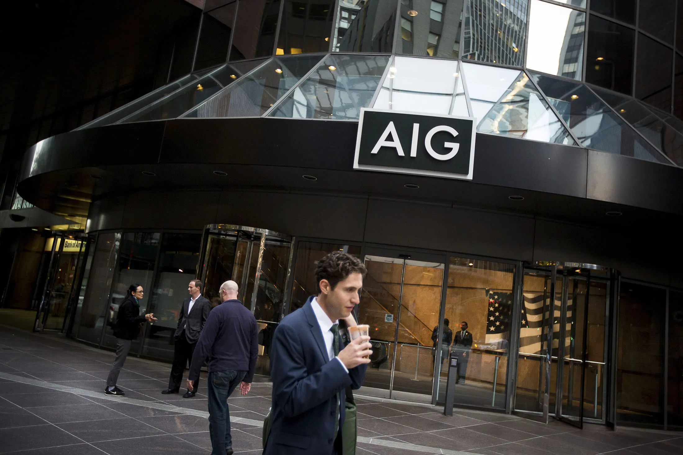 Pedestrians walk past the AIG headquarters in New York.
