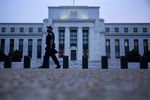 A Federal Reserve police officer walks past the Marriner S. Eccles Federal Reserve building in Washington, D.C..