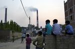 Emissions form a coal-fired power plant near residential property in Badarpur, Delhi, India.&nbsp;