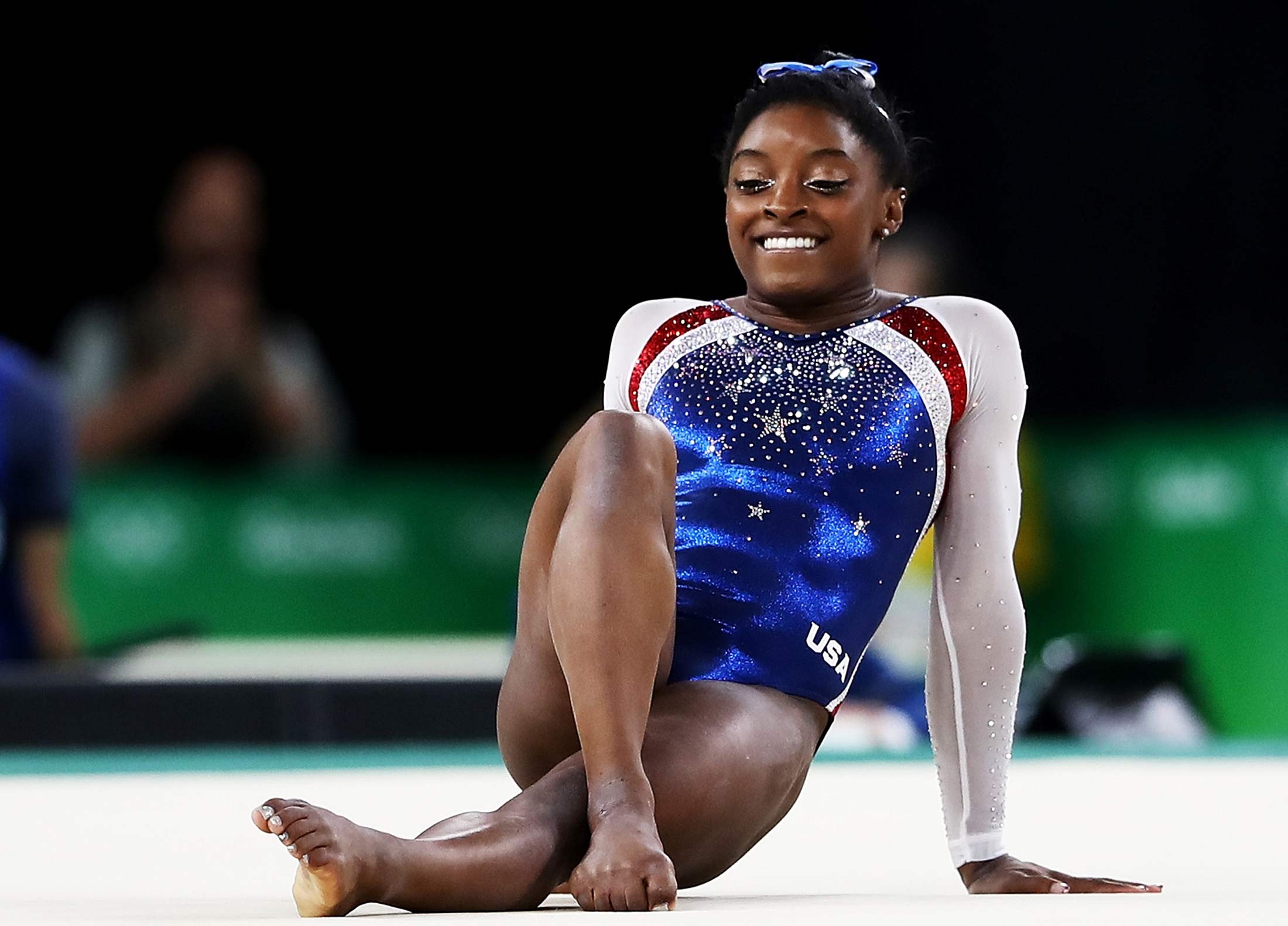 Russian gymnast stands on the podium with symbol supporting