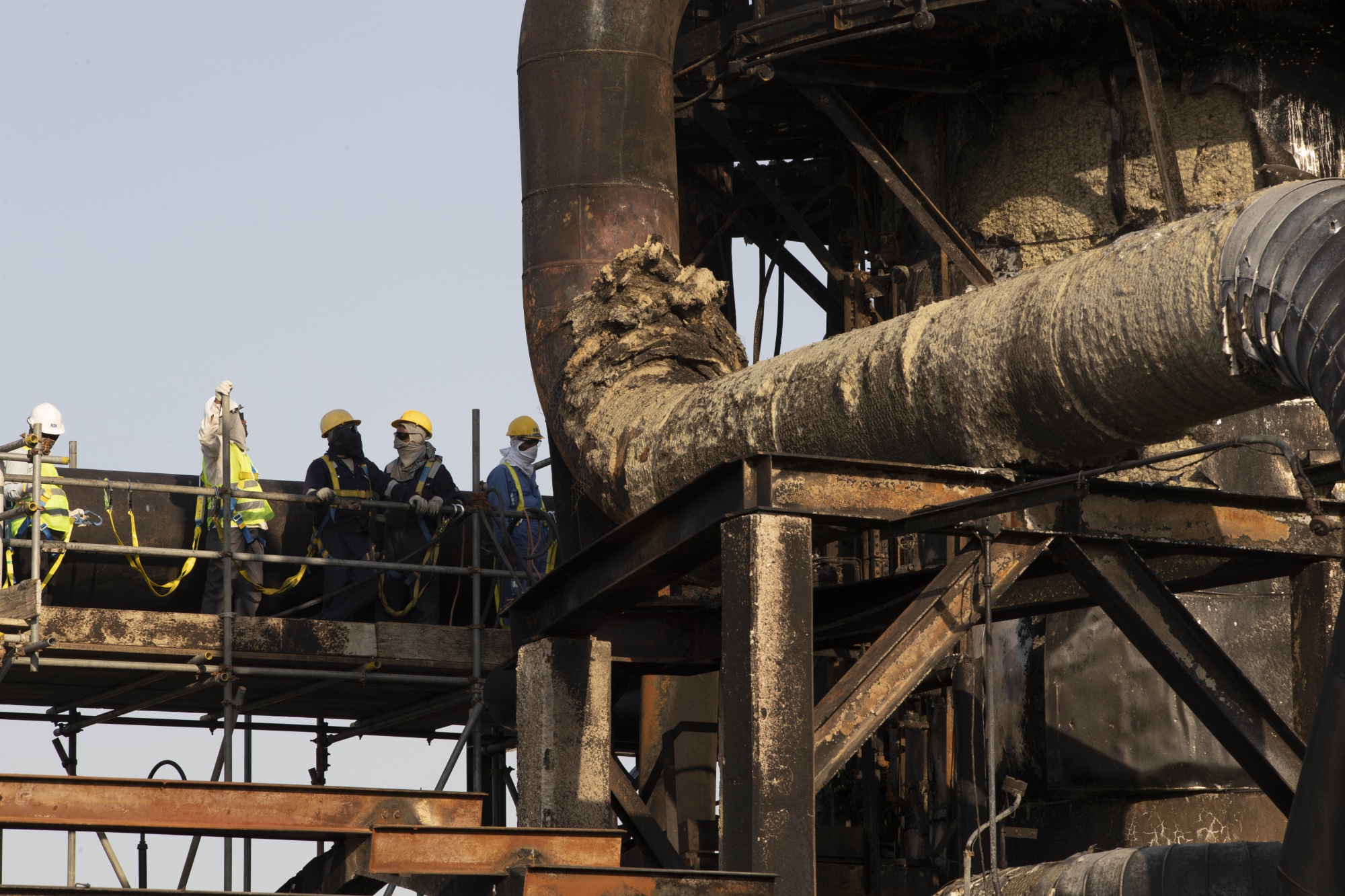 Workers repair a damaged refining tower at Saudi Aramco's Abqaiq crude oil processing plant&nbsp;on&nbsp;Sept. 20.&nbsp;