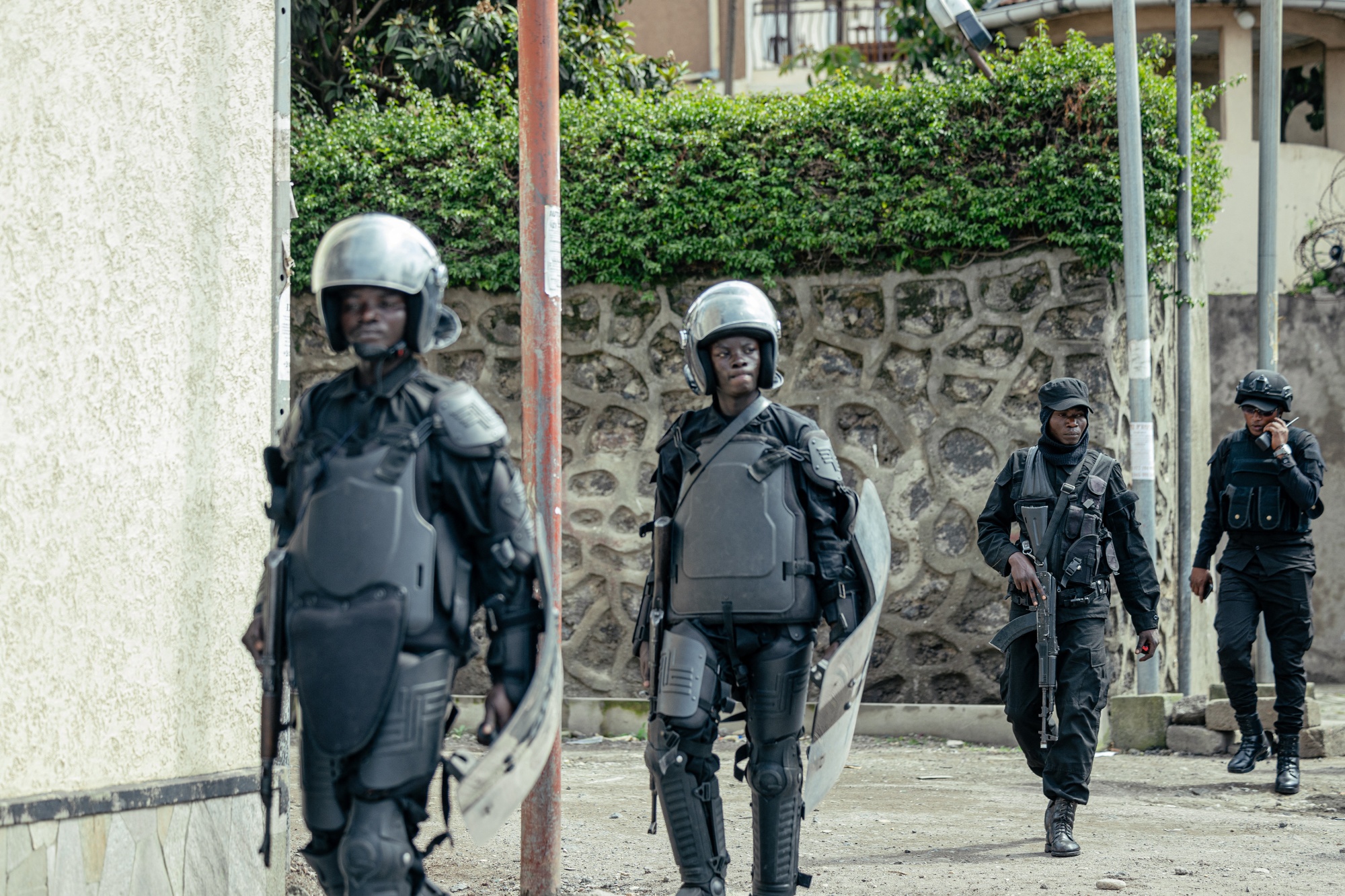 Members of the M23 wearing riot gear monitor protesters in Goma on March 12. Photographer: Jospin Mwisha/AFP/Getty Images